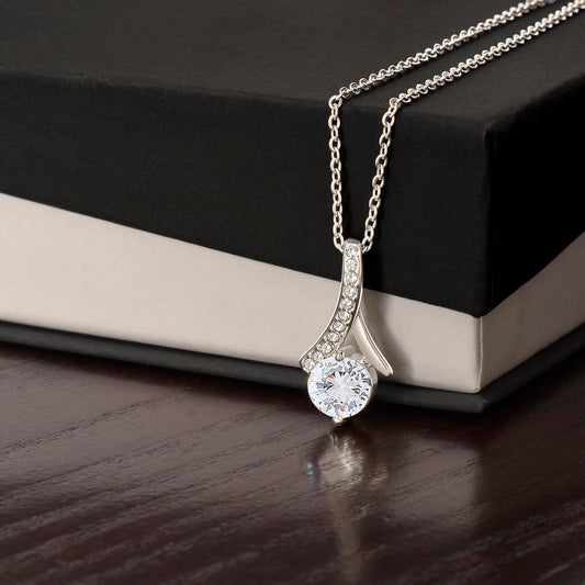 Alluring Beauty Necklace: a dazzling gold finish petite ribbon and sparkling cubic zirconia pendant